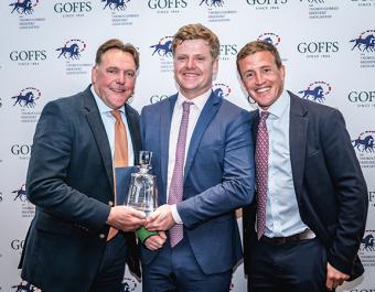 Dave Futter (left) and Will Kinsey of Peel Bloodstock (right), breeders of the Grade 1 performer High Class Hero, receiving the Mickley Stud Trophy from Finn Kent